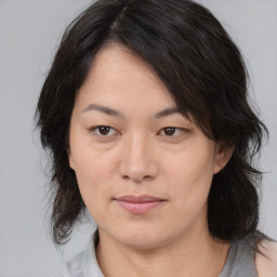 Joyful asian adult female with medium  brown hair and brown eyes