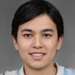 Joyful asian young-adult male with short  black hair and brown eyes