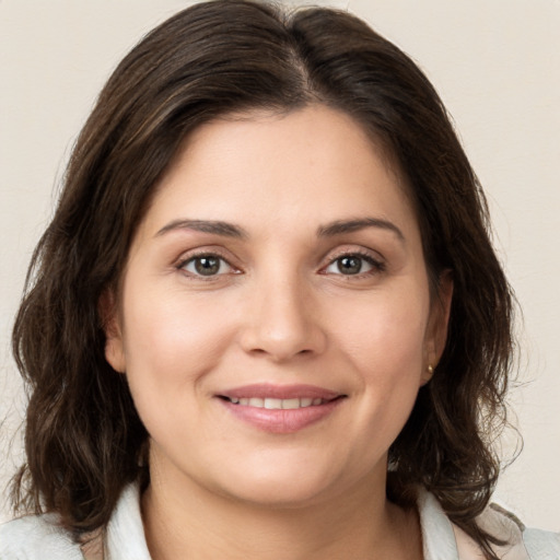 Joyful white young-adult female with medium  brown hair and brown eyes