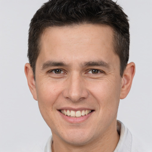 Joyful white young-adult male with short  brown hair and brown eyes