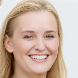 Joyful white young-adult female with long  brown hair and blue eyes