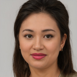 Joyful latino young-adult female with long  brown hair and brown eyes