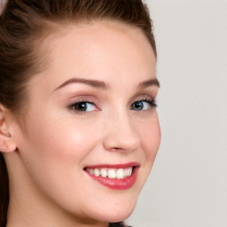 Joyful white young-adult female with long  brown hair and blue eyes