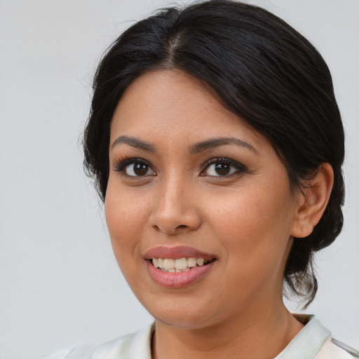 Joyful latino young-adult female with medium  brown hair and brown eyes