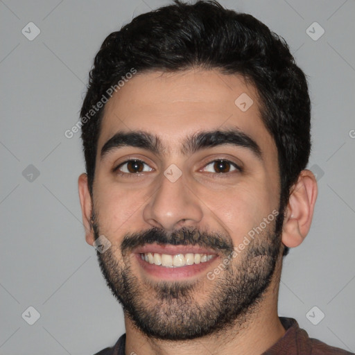 Joyful white young-adult male with short  black hair and brown eyes