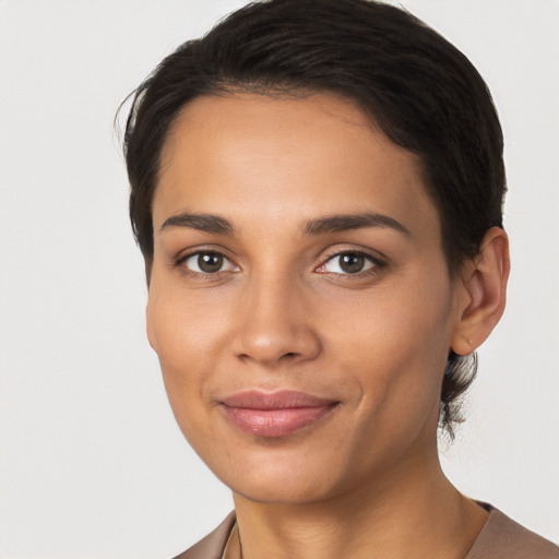 Joyful latino young-adult female with short  brown hair and brown eyes