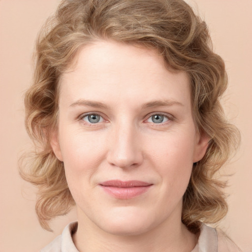 Joyful white young-adult female with medium  brown hair and blue eyes