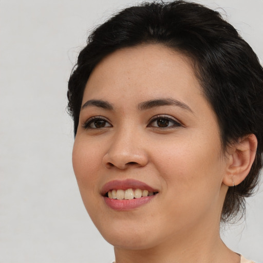 Joyful asian young-adult female with medium  brown hair and brown eyes