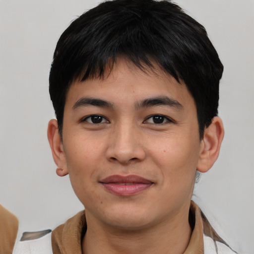 Joyful asian young-adult male with short  brown hair and brown eyes