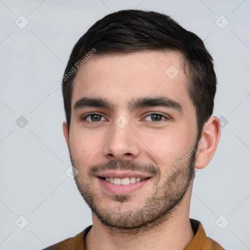 Joyful white young-adult male with short  black hair and brown eyes