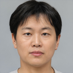 Neutral asian young-adult male with short  brown hair and brown eyes