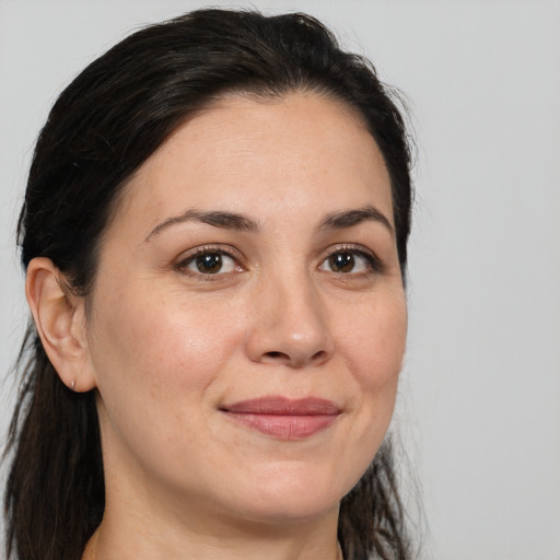 Joyful white adult female with medium  brown hair and brown eyes