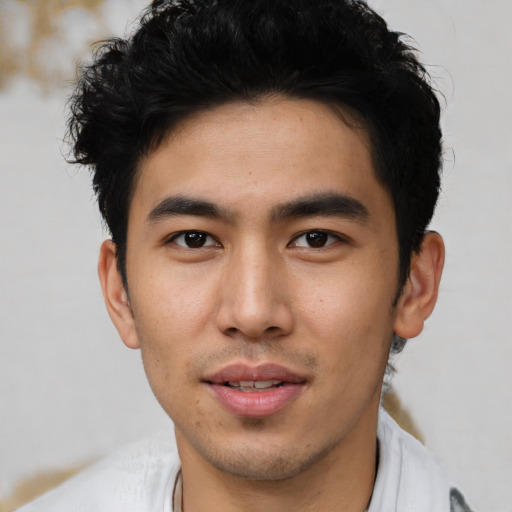 Joyful asian young-adult male with short  black hair and brown eyes