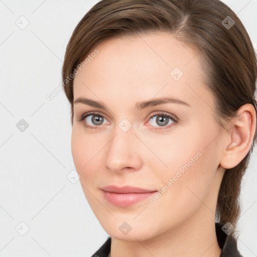 Joyful white young-adult female with medium  brown hair and grey eyes