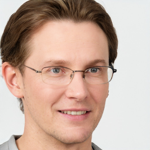 Joyful white adult male with short  brown hair and grey eyes