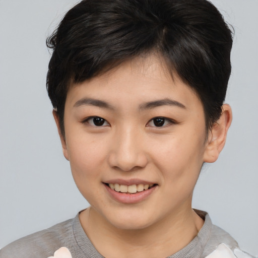 Joyful asian young-adult female with short  brown hair and brown eyes