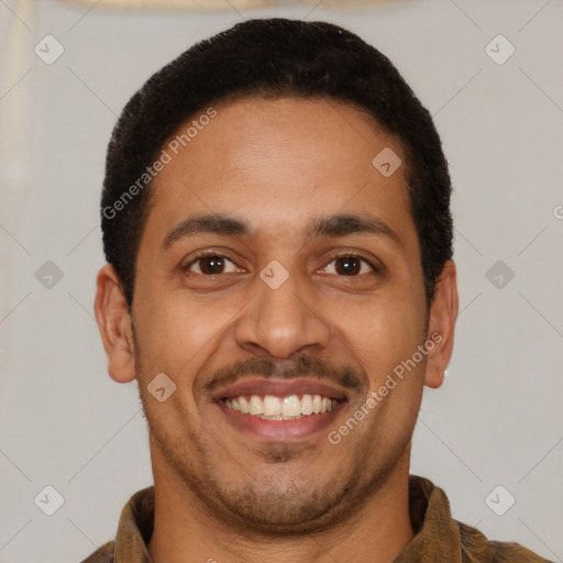 Joyful latino young-adult male with short  brown hair and brown eyes