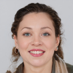 Joyful white young-adult female with medium  brown hair and blue eyes