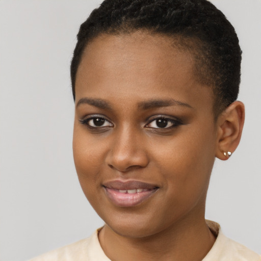 Joyful black young-adult female with short  brown hair and brown eyes