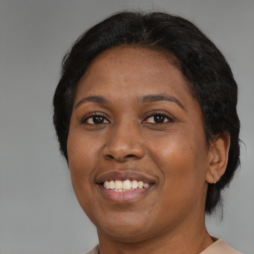 Joyful black young-adult female with medium  brown hair and brown eyes