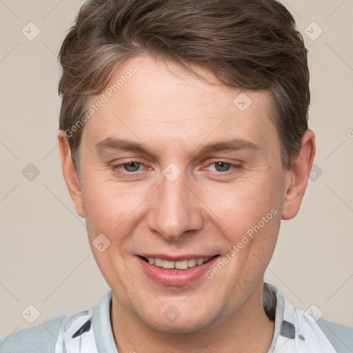 Joyful white adult male with short  brown hair and grey eyes