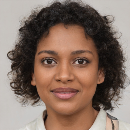 Joyful black young-adult female with medium  brown hair and brown eyes