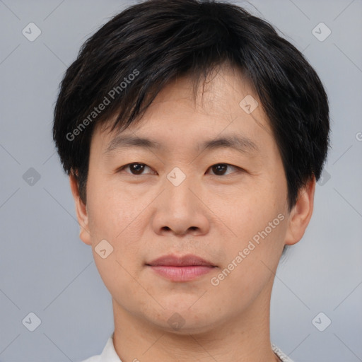 Joyful asian young-adult male with short  black hair and brown eyes