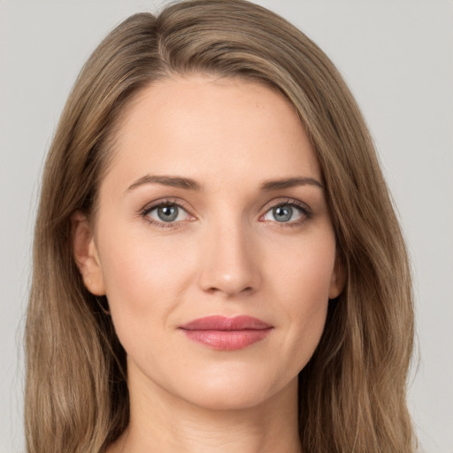 Joyful white young-adult female with long  brown hair and grey eyes