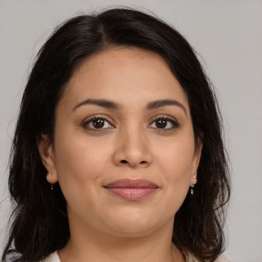 Joyful latino young-adult female with medium  brown hair and brown eyes