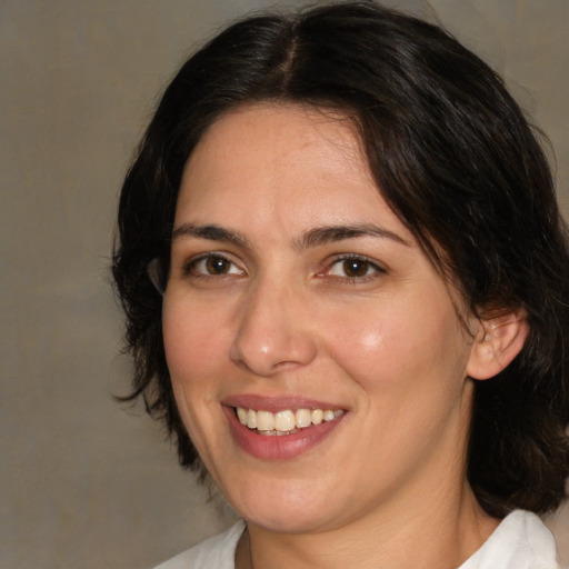 Joyful white adult female with medium  brown hair and brown eyes