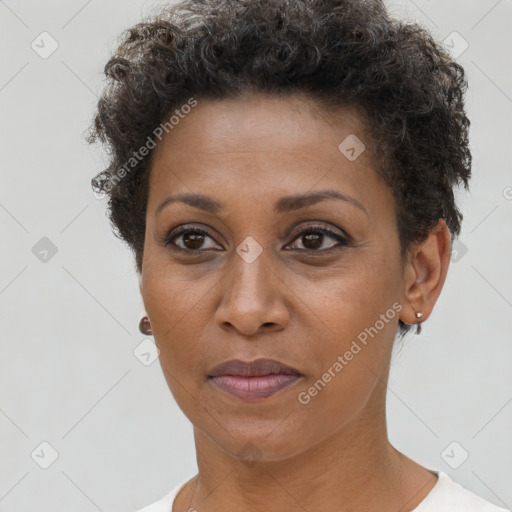 Joyful black young-adult female with short  brown hair and brown eyes