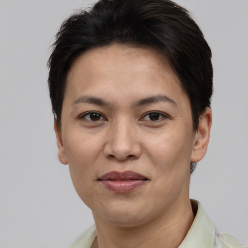 Joyful white adult female with short  brown hair and brown eyes