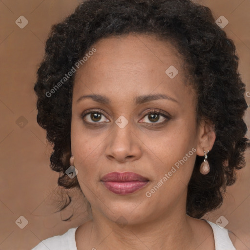 Joyful black adult female with medium  brown hair and brown eyes