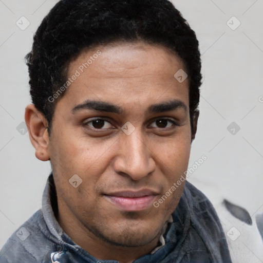 Joyful latino young-adult male with short  brown hair and brown eyes