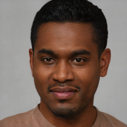 Joyful black young-adult male with short  black hair and brown eyes