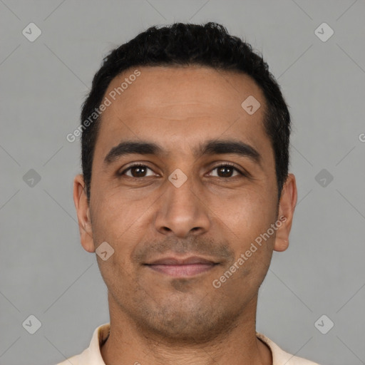 Joyful latino young-adult male with short  black hair and brown eyes