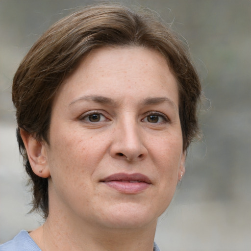 Joyful white adult female with medium  brown hair and grey eyes