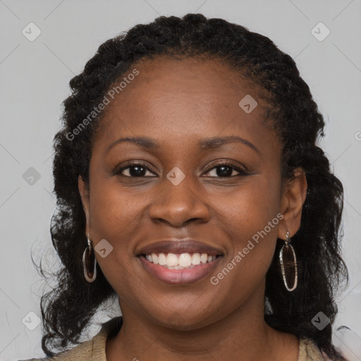 Joyful black young-adult female with long  brown hair and brown eyes