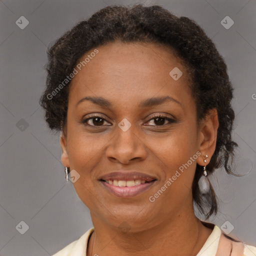 Joyful black adult female with short  brown hair and brown eyes