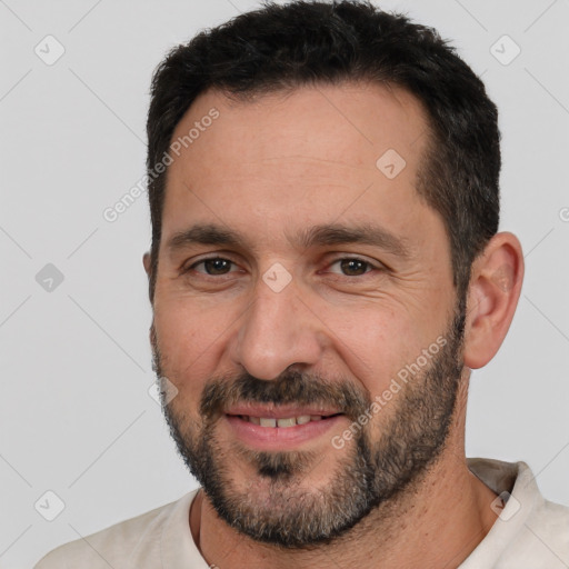 Joyful white adult male with short  black hair and brown eyes