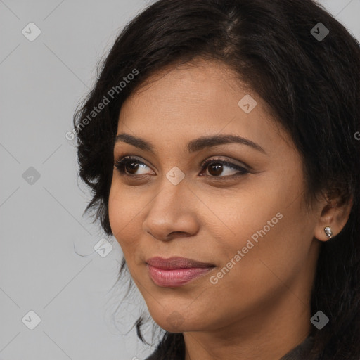 Joyful latino young-adult female with long  brown hair and brown eyes