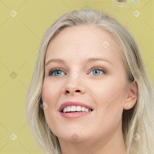 Joyful white young-adult female with long  brown hair and blue eyes