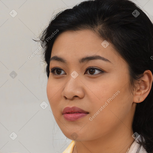 Joyful latino young-adult female with medium  brown hair and brown eyes