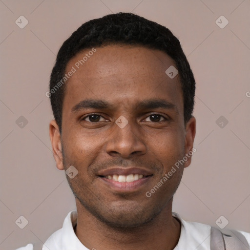 Joyful black young-adult male with short  black hair and brown eyes