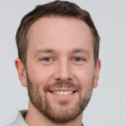 Joyful white adult male with short  brown hair and brown eyes