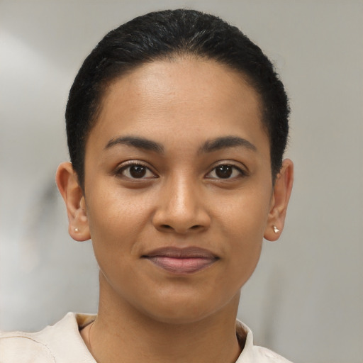 Joyful latino young-adult female with short  black hair and brown eyes