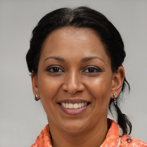 Joyful latino adult female with medium  brown hair and brown eyes