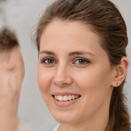 Joyful white adult female with long  brown hair and brown eyes