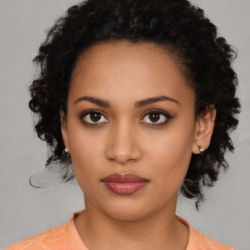 Joyful latino young-adult female with medium  black hair and brown eyes