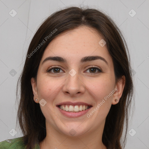 Joyful white young-adult female with long  brown hair and brown eyes